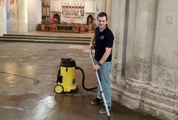 member of Scott & Sons team carefully cleaning a cathedral floor